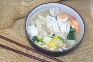 Noodle in creamy gravy sauce with shrimp and squid