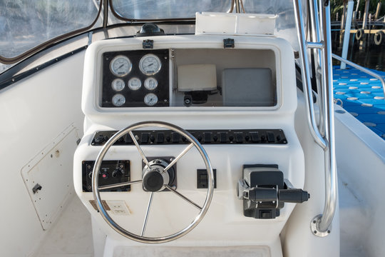 White yacht control panel with steering wheel