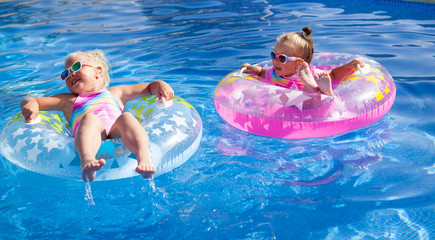 little pretty girls is swimming in pool
