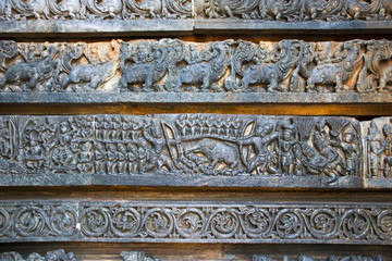 Depiction of Arjuna-Kirata, Shiva, hunting the pig, at the base of temple, Hoysaleshwara temple, Halebidu, Karnataka