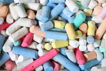 Many colorful dirty broken chalk pile for background