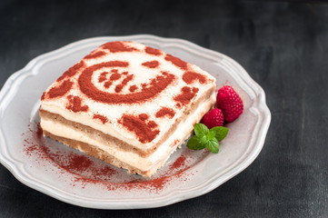 Italian tiramisu dessert with raspberries and mint