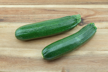 Organic green zucchini from my farm on wooden background