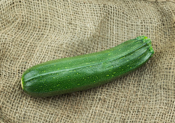 Organic homegrown green zucchini from my farm on jute background