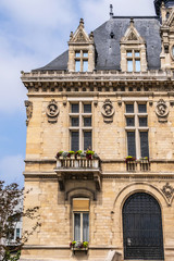 Fototapeta na wymiar View of Vincennes Hotel de ville (1887 - 1891) or Town hall of Vincennes. Vincennes - a commune in the Val-de-Marne department in the eastern suburbs of Paris, France.