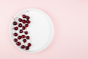 Ripe cherry on a pink background. Top view, copy space. Food background