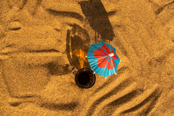 colorful shots drinks on a sandy beach with umbrellas for drinks