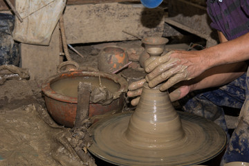 Hands of Professional Thai man using mechanic pottery made earthenware at 