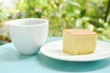 butter cake slice for piece on plate and black coffee cup