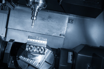 The 5-axis CNC milling machine or machining center cutting the automotive part with the solid ball endmill tool in the light blue scene.The Hi-Technology manufacturing process.