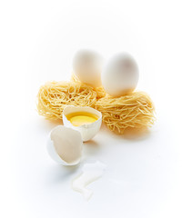 egg pasta and chicken eggs with yolk on a white background