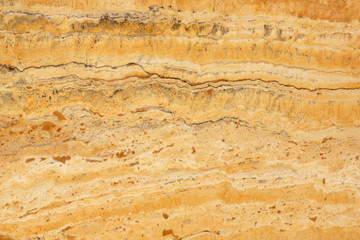 A natural stone, a polished yellow marble called Travertino Giallo