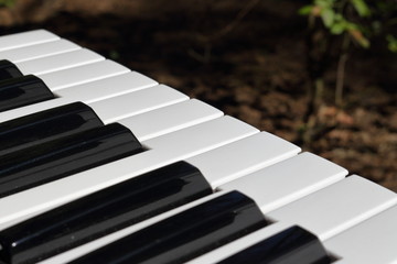 Piano keyboard outdoors in the afternoon sun