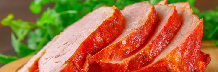 Sliced Roast Pork Loin on a brown wooden table with cilantro.