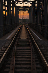 Fototapeta na wymiar steel railway bridge on sunset
