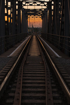 steel railway bridge on sunset