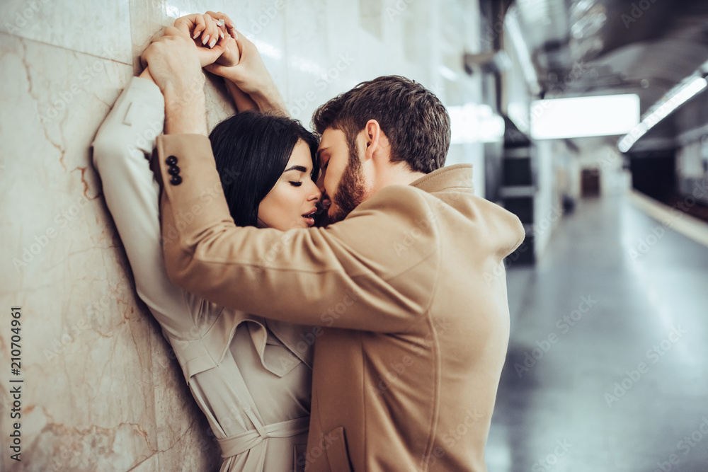 Wall mural young romantic couple in subway