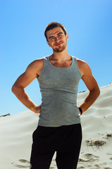 Fototapeta premium the guy with dark hair. bright sun light is blinding