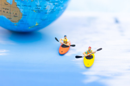 Miniature people : Traveler boating, kayaking in the ocean. Image use for Sports and Tourism concept.