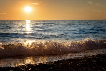 Waves on the beach at sunset
