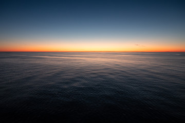 Empty landscape with calm sea and scenic sunset in Gulf of Finland