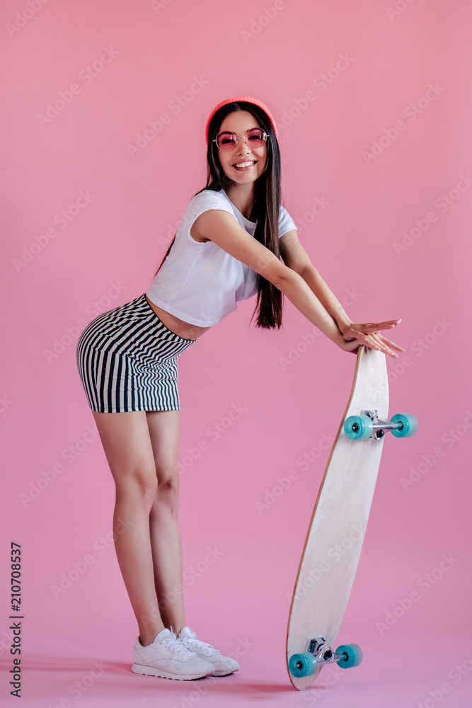 Wall mural young girl on pink background