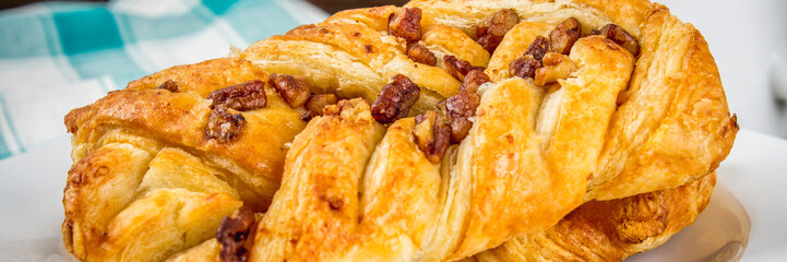 Danish pastry maple pecan with nuts and maple syrup banner