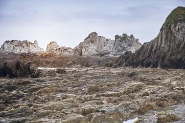 Rocky landscape with sunrise trough the rocks with cloudy blue sky