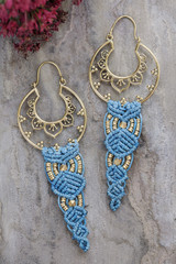 Macrame brass earrings on natural background