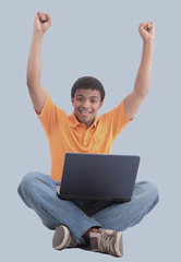 Happy african man with a laptop - isolated over a gray