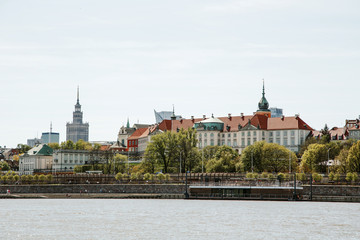 Fototapeta premium Miasto nad rzeką. Warszawa nad Wisłą. Stare miasto to Bulwary Polskie i Wiedeńskie. Stare i stare części miasta. Architektura. Świątynie i kościoły. Wysokie budynki i zabytkowe