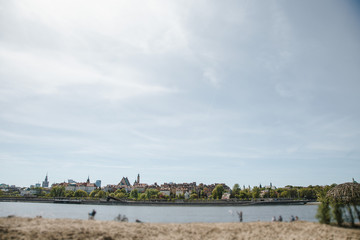 Fototapeta premium City over the river. Warsaw over the Vistula. The old town is the Polish and Viennese Boulevards. Old and owen parts of the city. Architecture. Temples and churches. High-rise buildings and historic