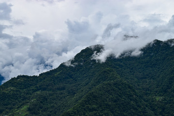 Fototapeta na wymiar Clouds Kissing The Mountain Peak