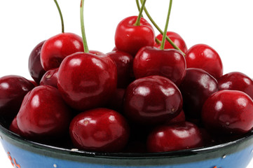 Cherries in a plate on a white background. Front view.