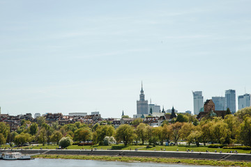 Fototapeta na wymiar City over the river. Warsaw over the Vistula. The old town is the Polish and Viennese Boulevards. Old and owen parts of the city. Architecture. Temples and churches. High-rise buildings and historic