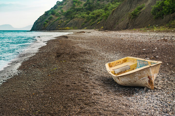 Lonely boat on the sunset beach