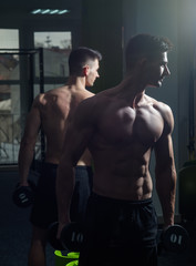 Fototapeta na wymiar Man with torso, muscular macho and his reflexion in mirror background. Sport and gym concept. Sportsman, athlete with muscles looks attractive. Man with nude torso in gym enjoy his sporty lifestyle