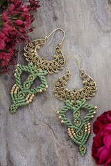 Macrame brass earrings on natural background