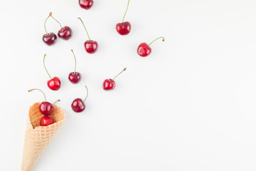 Ripe cherries in a waffle cone isolated