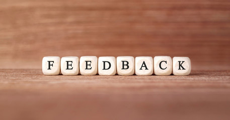 Word FEEDBACK made with wood building blocks