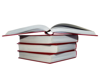 Red covered opened book with pages fluttering, on stack of books. White background.