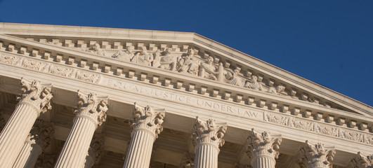 Close up photo of the US Supreme Court motto 