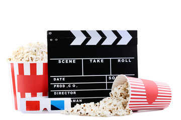 Clapper board with popcorn in striped buckets and glasses on white background