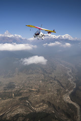 Fototapeta na wymiar Ultralight plane and trike fly and Machapuchare summit