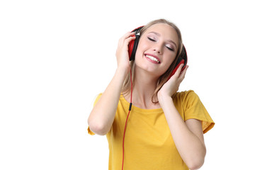 Naklejka premium Young woman with headphones on white background