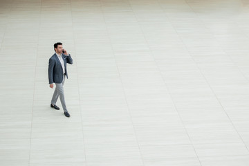 far away.businessman with a smartphone is moving forward