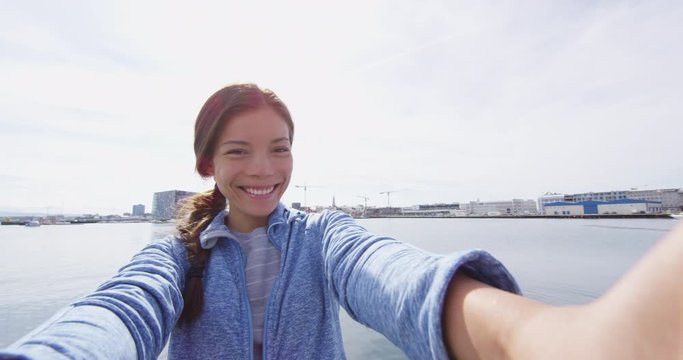 Travel selfie video by woman on travel in Reykjavik Harbor, Iceland. Girl visiting Landmarks and tourist attractions in Iceland capital Reykjavik. SLOW MOTION RED EPIC.
