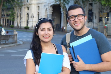Two mixed race students smiling outdoors