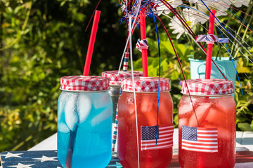 Outdoor party table with drinks for American Independence Day celebration.