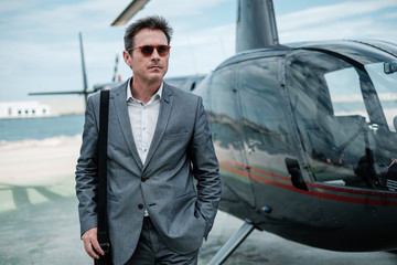 Businessman near private helicopter